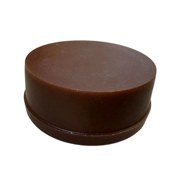 Side view of an original Soviet military black boot cream container from the Cold War era.