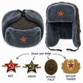 Grey ushanka with ear flaps raised and lowered, showing four badge choices: red star, green star, olive officer field cockade and gold officer parade cockade.