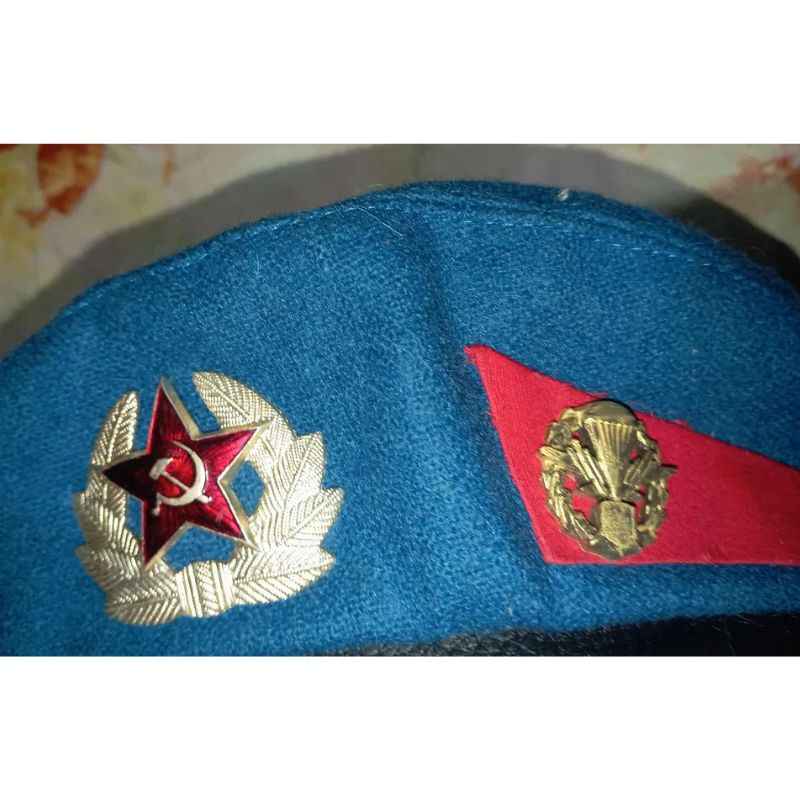 Close-up of Soviet VDV blue beret badge and red paratrooper insignia