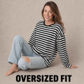 Woman wearing oversized black and white striped Telnyashka long sleeve shirt