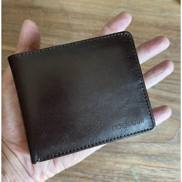 Compact Yuri Gagarin leather wallet shown in hand for size reference